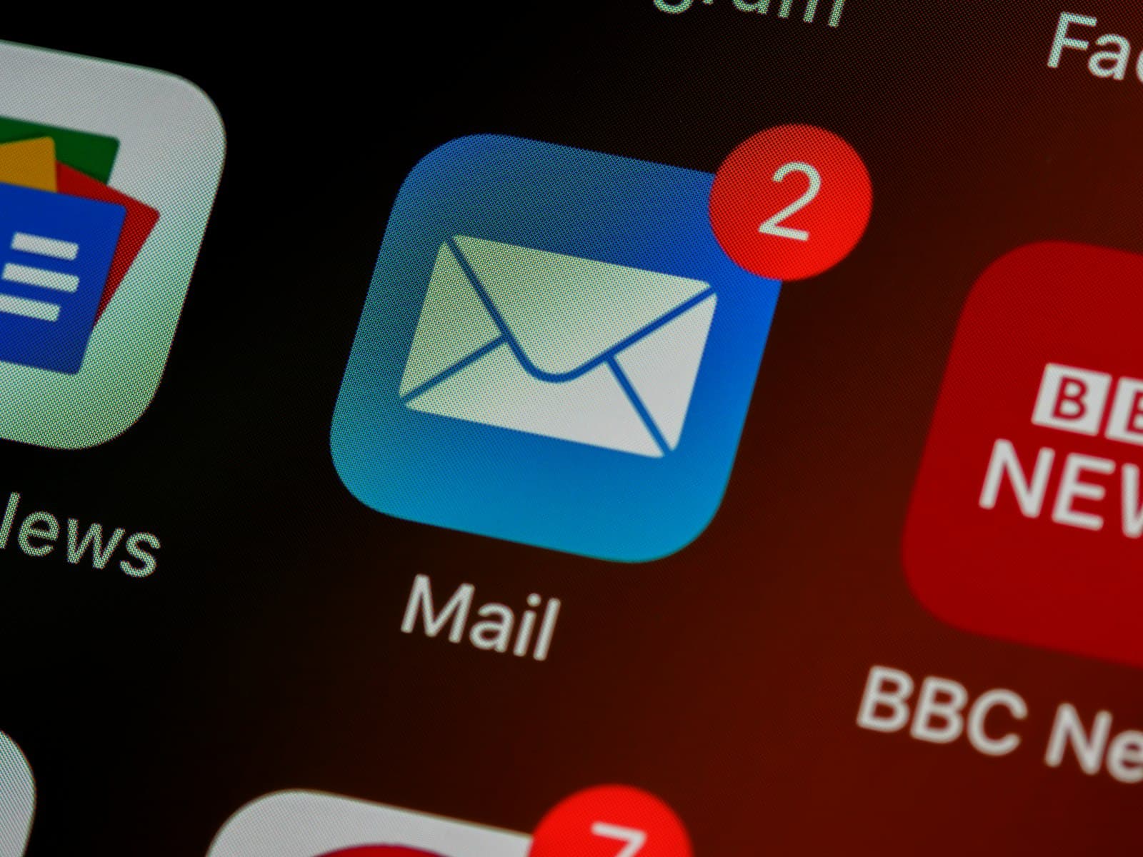 A close-up of a phone screen showing a mail app icon with a notification badge — the inbound channel where every abuse report lands.